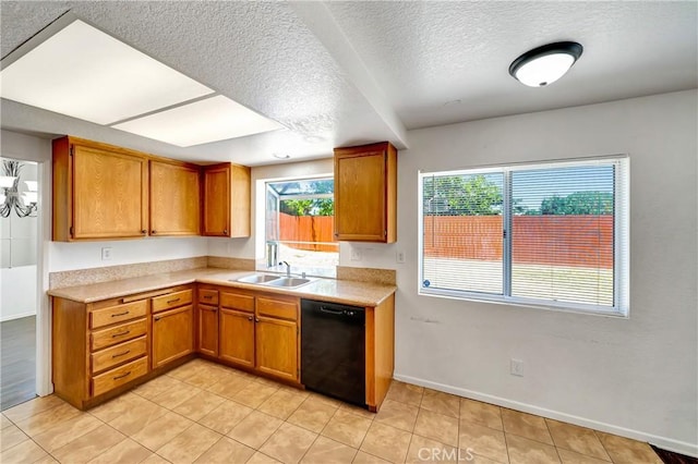 3115 Crowne Dr, Palmdale, CA 93551 - kitchen featuring dishwasher, light countertops, brown cabinetry, a textured ceiling, and light tile patterned floors