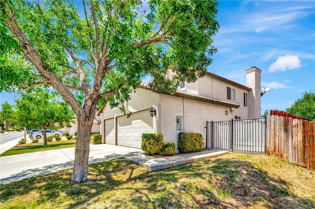 3115 Crowne Dr, Palmdale, CA 93551 - view of home's exterior with concrete driveway, a chimney, a garage, and stucco siding