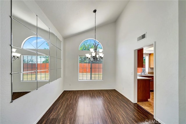 3115 Crowne Dr, Palmdale, CA 93551 - unfurnished dining area with a chandelier, wood finished floors, and high vaulted ceiling