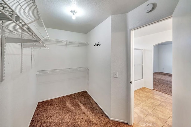 3115 Crowne Dr, Palmdale, CA 93551 - spacious closet featuring light carpet and arched walkways