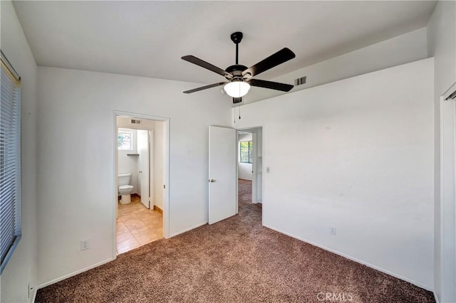 3115 Crowne Dr, Palmdale, CA 93551 - unfurnished bedroom featuring light carpet, ensuite bathroom, and a ceiling fan