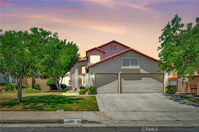 3115 Crowne Dr, Palmdale, CA 93551 - view of front facade with an attached garage, stucco siding, a tiled roof, and driveway
