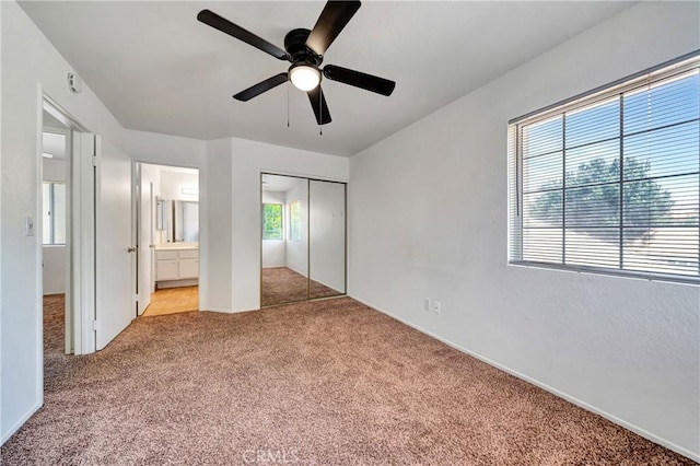 3115 Crowne Dr, Palmdale, CA 93551 - unfurnished bedroom with carpet flooring, a closet, ensuite bathroom, and ceiling fan