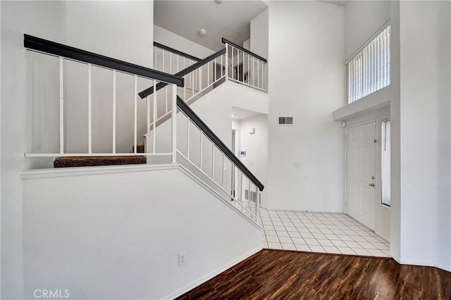 3115 Crowne Dr, Palmdale, CA 93551 - entryway with wood finished floors, stairway, and a towering ceiling