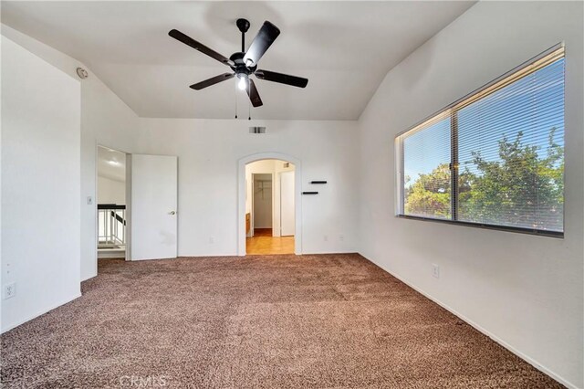 3115 Crowne Dr, Palmdale, CA 93551 - unfurnished bedroom with arched walkways, carpet, vaulted ceiling, and ceiling fan