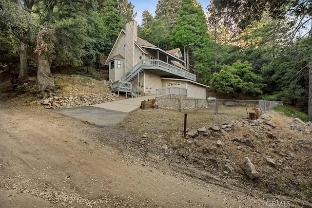 21658 W Buckthorne Dr, Cedarpines Park, CA 92322 - view of side of property featuring a deck, stairs, and a chimney