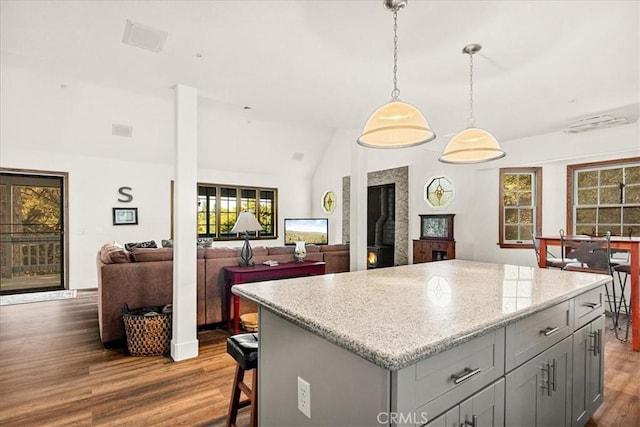 21658 W Buckthorne Dr, Cedarpines Park, CA 92322 - kitchen with gray cabinets, vaulted ceiling, dark wood-type flooring, a kitchen island, and hanging light fixtures