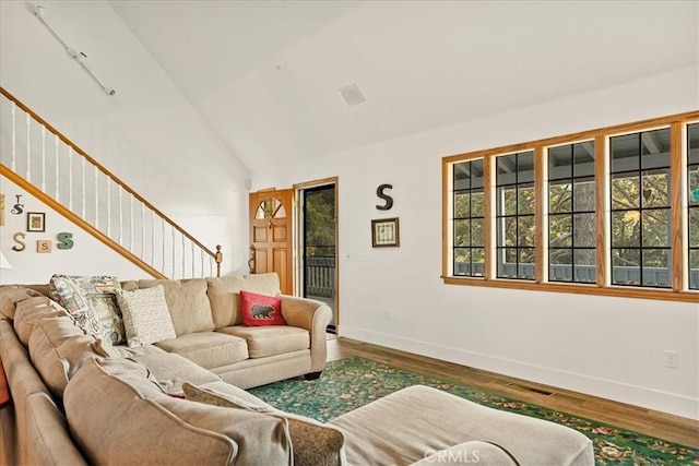 21658 W Buckthorne Dr, Cedarpines Park, CA 92322 - living room featuring plenty of natural light, wood finished floors, stairway, and high vaulted ceiling