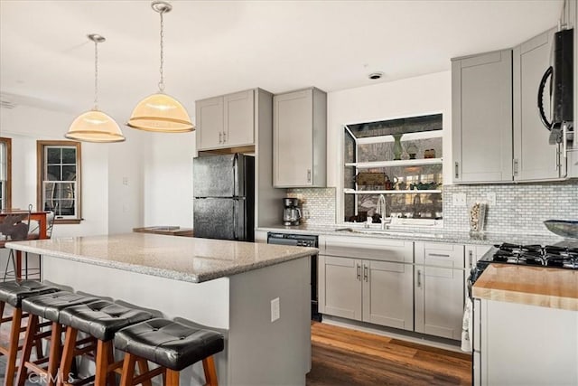21658 W Buckthorne Dr, Cedarpines Park, CA 92322 - kitchen featuring black appliances, gray cabinets, tasteful backsplash, a kitchen island, and dark wood finished floors