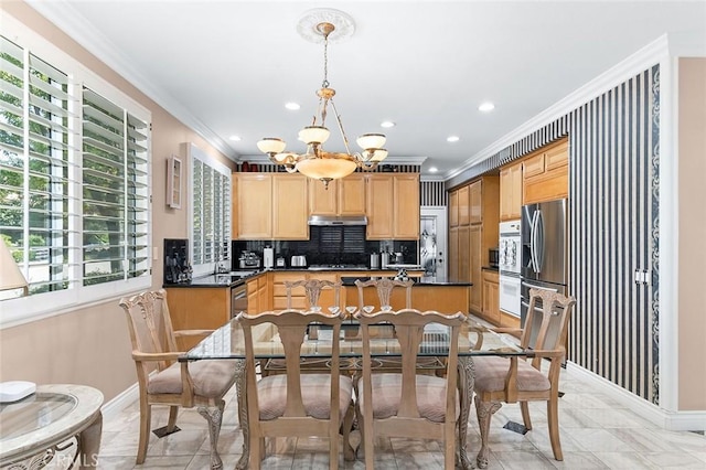 15075 Avenida Del Monte, Chino Hills, CA 91709 - kitchen with light brown cabinetry, ornamental molding, a chandelier, dark countertops, and under cabinet range hood