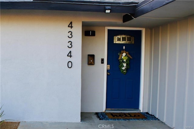 43340 Illinois, Palm Desert, CA 92211 - doorway to property featuring stucco siding
