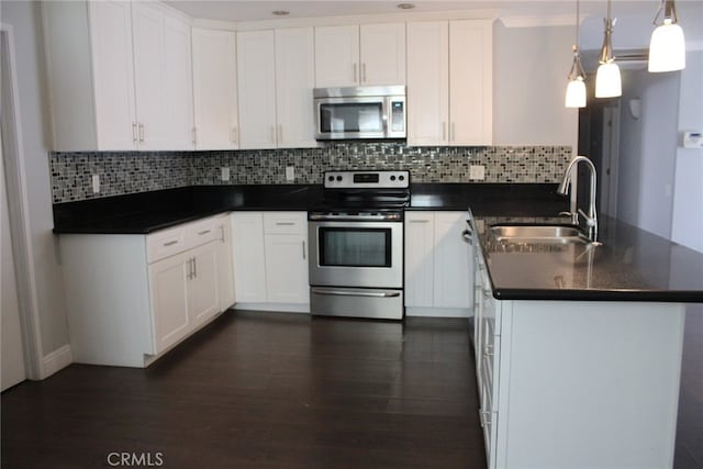 43340 Illinois, Palm Desert, CA 92211 - kitchen with appliances with stainless steel finishes, a peninsula, dark countertops, and decorative backsplash