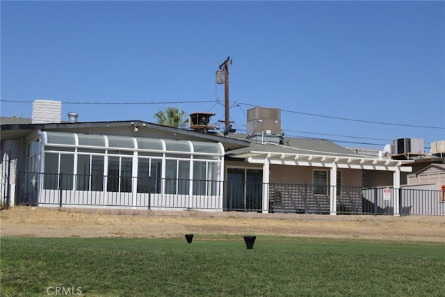 43340 Illinois, Palm Desert, CA 92211 - back of property featuring a sunroom and a lawn