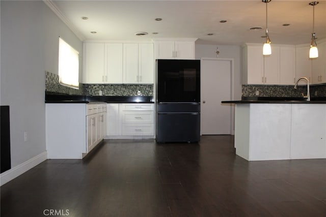 43340 Illinois, Palm Desert, CA 92211 - kitchen featuring freestanding refrigerator, dark countertops, backsplash, white cabinets, and ornamental molding