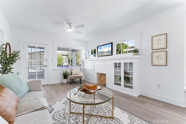 765 Loma Ave Unit 769, Long Beach, CA 90804 - living area featuring plenty of natural light, a ceiling fan, light wood-style flooring, and a fireplace