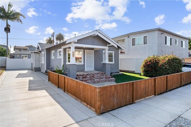 765 Loma Ave Unit 769, Long Beach, CA 90804 - view of front facade with covered porch, a fenced front yard, and concrete driveway