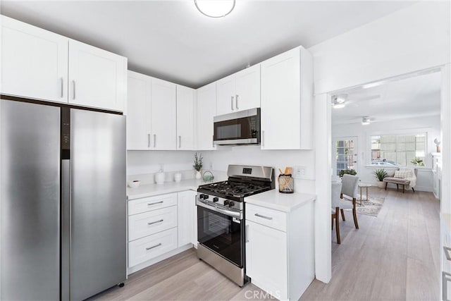 765 Loma Ave Unit 769, Long Beach, CA 90804 - kitchen with stainless steel appliances, light countertops, light wood-style flooring, and a ceiling fan