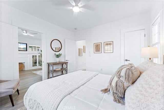 765 Loma Ave Unit 769, Long Beach, CA 90804 - bedroom with wood finished floors, a fireplace, and a ceiling fan