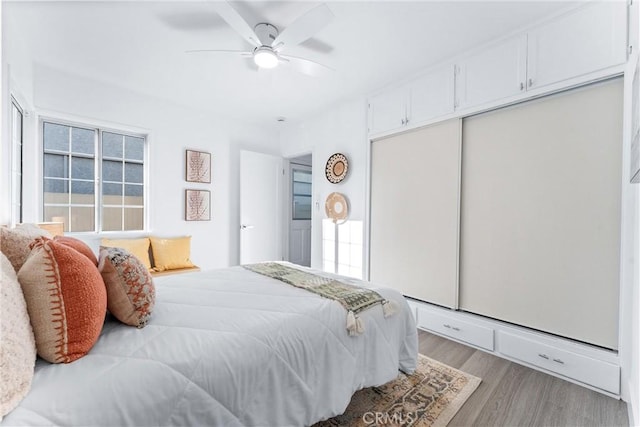 765 Loma Ave Unit 769, Long Beach, CA 90804 - bedroom featuring wood finished floors, a closet, multiple windows, and a ceiling fan