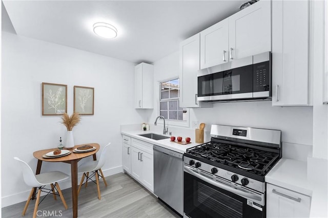 765 Loma Ave Unit 769, Long Beach, CA 90804 - kitchen featuring stainless steel appliances, light wood-style flooring, light countertops, and white cabinetry