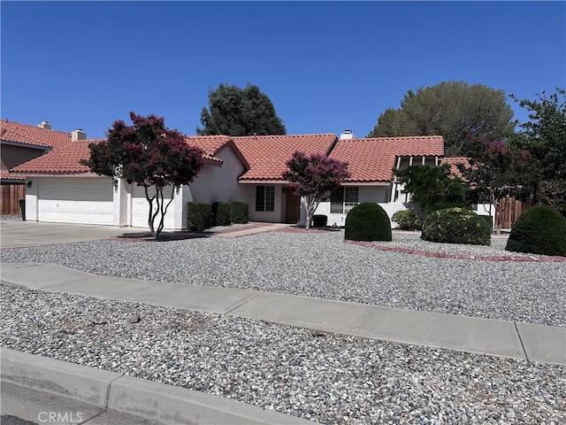 12429 Pocono Pl, Apple Valley, CA 92308 - view of front of home with a tile roof, a garage, concrete driveway, and stucco siding
