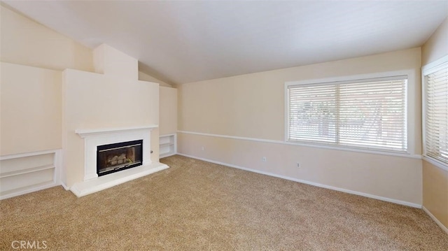 12429 Pocono Pl, Apple Valley, CA 92308 - unfurnished living room with carpet, a glass covered fireplace, and vaulted ceiling
