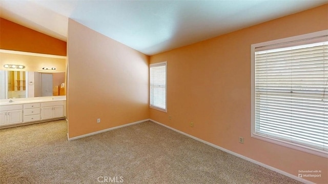 12429 Pocono Pl, Apple Valley, CA 92308 - unfurnished bedroom featuring lofted ceiling, multiple windows, light colored carpet, and ensuite bath