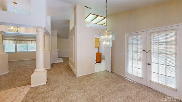 12429 Pocono Pl, Apple Valley, CA 92308 - unfurnished dining area featuring carpet floors, a chandelier, and french doors