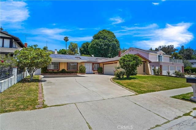 17149 Gledhill St, Northridge, CA 91325 - view of front facade with roof mounted solar panels, a garage, driveway, and a chimney