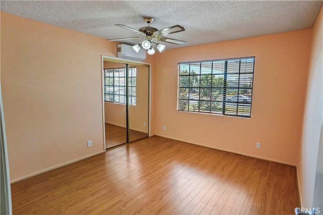 17149 Gledhill St, Northridge, CA 91325 - spare room with an AC wall unit, a textured ceiling, wood finished floors, and a ceiling fan
