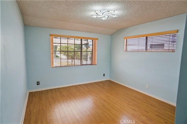 17149 Gledhill St, Northridge, CA 91325 - empty room with plenty of natural light, wood finished floors, and a textured ceiling