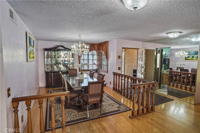 17149 Gledhill St, Northridge, CA 91325 - dining room featuring a chandelier, wood finished floors, and a textured ceiling
