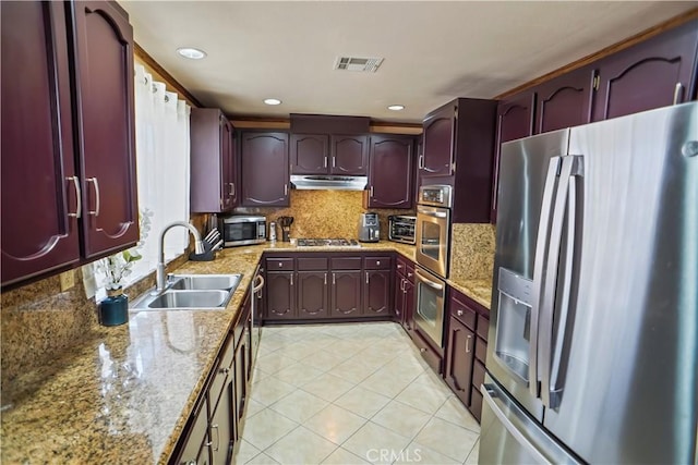 17149 Gledhill St, Northridge, CA 91325 - kitchen featuring appliances with stainless steel finishes, reddish brown cabinets, under cabinet range hood, light tile patterned floors, and recessed lighting