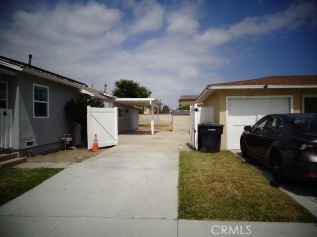 15728 Stevens Ave, Bellflower, CA 90706 - view of side of property with driveway and stucco siding