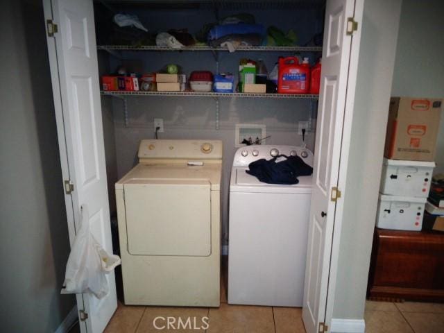 15728 Stevens Ave, Bellflower, CA 90706 - washroom with washing machine and dryer and light tile patterned flooring