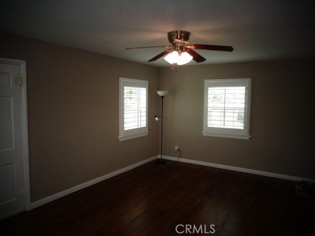 15728 Stevens Ave, Bellflower, CA 90706 - spare room with a ceiling fan and dark wood-type flooring
