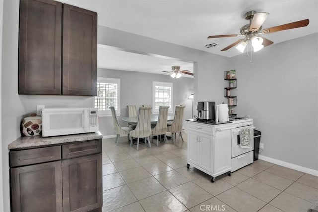 15728 Stevens Ave, Bellflower, CA 90706 - kitchen featuring white appliances, light tile patterned flooring, ceiling fan, dark brown cabinetry, and light countertops