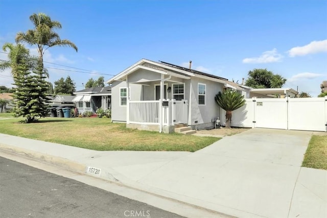 15728 Stevens Ave, Bellflower, CA 90706 - single story home featuring a gate, concrete driveway, roof mounted solar panels, stucco siding, and a porch