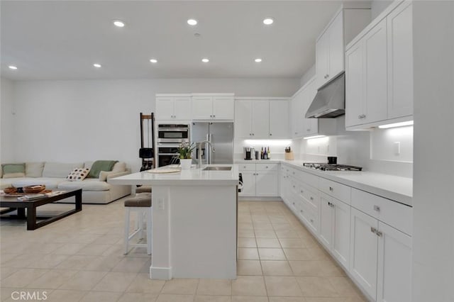 145 Sash, Irvine, CA 92618 - kitchen featuring stainless steel appliances, under cabinet range hood, light tile patterned flooring, light countertops, and white cabinets