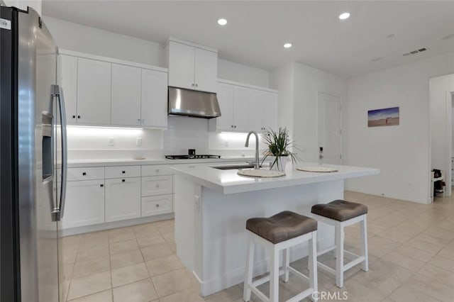 145 Sash, Irvine, CA 92618 - kitchen featuring stainless steel fridge, under cabinet range hood, light countertops, stovetop, and white cabinetry
