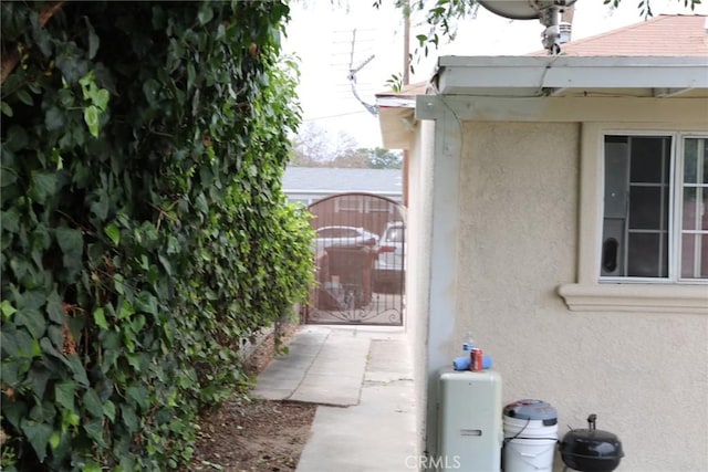 3641 W Oak Ave, Fullerton, CA 92833 - view of side of property featuring stucco siding and a gate