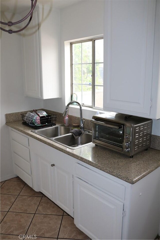 3641 W Oak Ave, Fullerton, CA 92833 - kitchen featuring white cabinets and light tile patterned floors