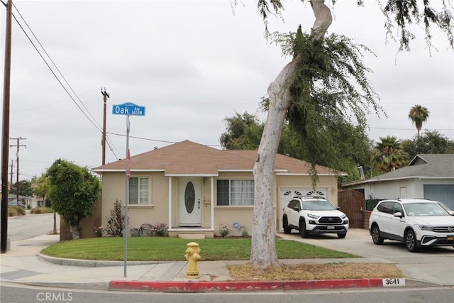 3641 W Oak Ave, Fullerton, CA 92833 - view of front of property featuring a garage, stucco siding, driveway, and a front lawn
