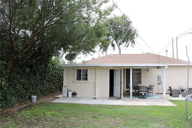3641 W Oak Ave, Fullerton, CA 92833 - rear view of property featuring a patio area, stucco siding, and a yard