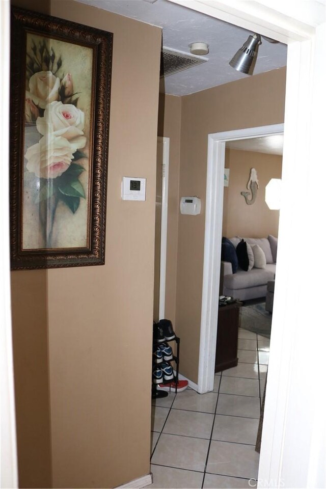3641 W Oak Ave, Fullerton, CA 92833 - hall featuring light tile patterned floors and baseboards