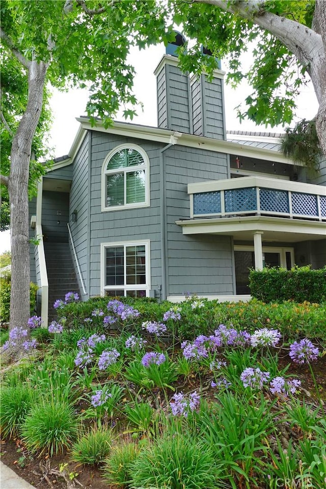 7262 Yellowtail Dr Unit 206, Huntington Beach, CA 92648 - view of home's exterior featuring a balcony and a chimney