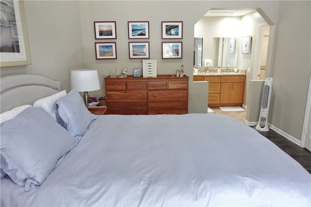 7262 Yellowtail Dr Unit 206, Huntington Beach, CA 92648 - bedroom featuring wood finished floors, arched walkways, and ensuite bathroom