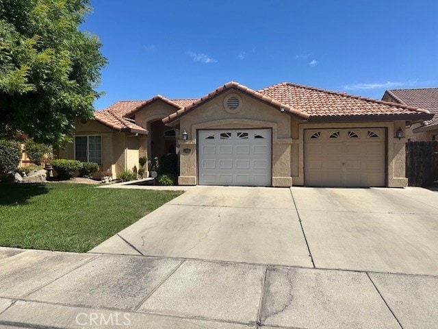 757 Nighthawk Ct, Merced, CA 95340 - view of front of home featuring a garage, concrete driveway, stucco siding, and a tiled roof