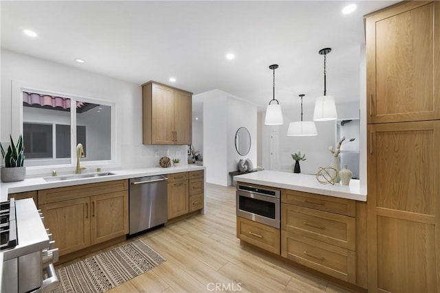 44 Seton Rd, Irvine, CA 92612 - kitchen featuring stainless steel appliances, light wood-style flooring, hanging light fixtures, light countertops, and recessed lighting
