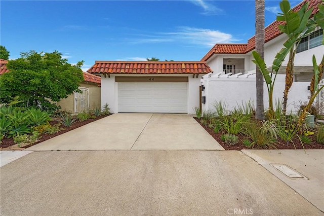 44 Seton Rd, Irvine, CA 92612 - mediterranean / spanish-style house with a tile roof, stucco siding, driveway, an attached garage, and a gate